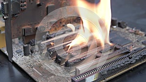 Computer motherboard ,circuit board is on fire to burn,flame. short circuit, burns computer chip