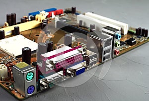 Computer Motherboard with power connector socket, gray background,