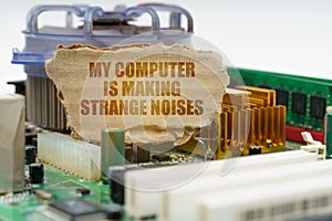 On the computer motherboard there is a cardboard with the inscription - My computer is making strange noises photo