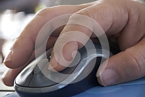 Computer mouse close-up male hand.