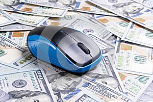 Computer mouse on dollars background