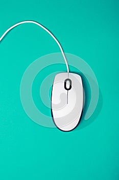 Computer mouse on emerald background