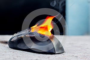 Computer mouse in flames. Careless handling of equipment, fire