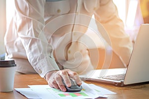 Computer mouse in hand, Man office staff are analyzing graphs.