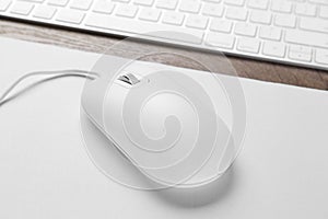 Computer mouse with mousepad and keyboard on table