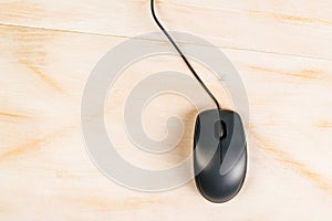 Computer mouse on office desk, top view