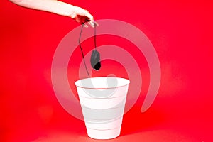 A computer mouse with a wire is thrown into the office wastebasket.