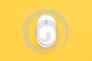 Computer mouse on a yellow background isolated, flat lay.