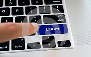 Computer notebook keyboard with Learn key, silver laptop with black keyboards, finger want to press the key