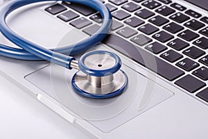 Computer notebook or laptop and stethoscope. Checking virus or d