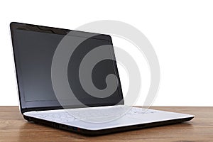 Computer notebook on white and wooden background.