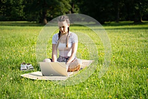 Computer outdoor. Student girl working on laptop, tablet in summer park. Woman person business nature outside with