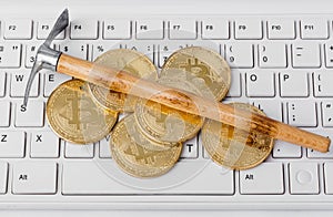 Computer and pickaxe on bitcoins