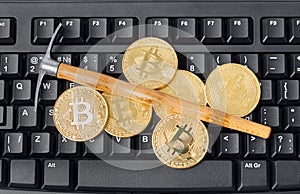 Computer and pickaxe on bitcoins