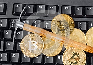 Computer and pickaxe on bitcoins
