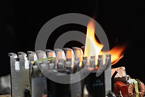 computer power burning, on a black background, close-up, short circuit, electrical equipment ignition