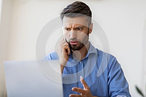 Computer Problem. Concerned Millennial Businessman Talking On Cellphone With Customer Support,