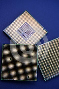 A computer processor on a blue background. Contacts on the processor case