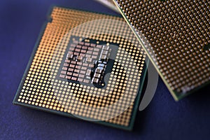 A computer processor on a blue background. Contacts on the processor case