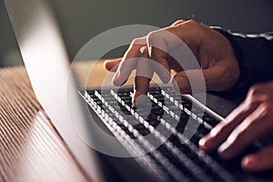 Computer programmer and hacker hands typing laptop keyboard photo