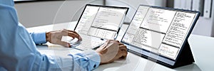 Computer Programmer Writing Program Code On Computer