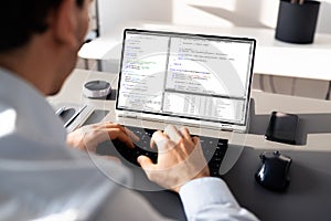 Computer Programmer Writing Program Code On Computer