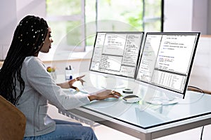 Computer Programmer Writing Program Code On Computer