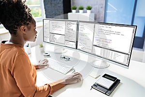 Computer Programmer Writing Program Code On Computer