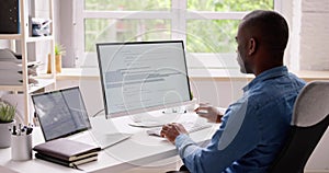 Computer Programmer Writing Program Code On Computer