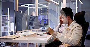 Computer Programmer Writing Program Code On Computer