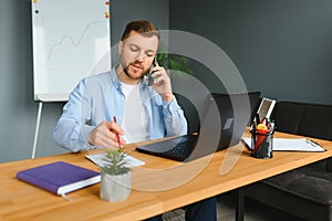 Computer Programmer Writing Program Code On Computer In Office