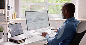 Computer Programmer Writing Program Code On Computer