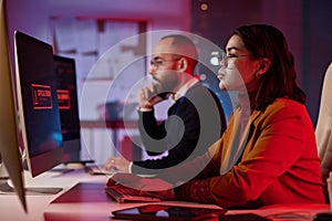 Computer Programmers in IT Security Office with Red Light