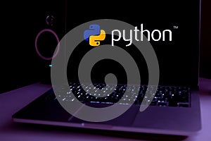 Computer with the Python logo is an interpreted programming language whose philosophy