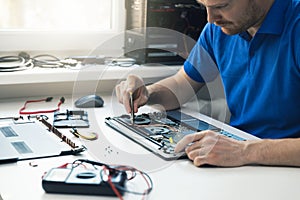Computer repair service - technician repairing broken laptop