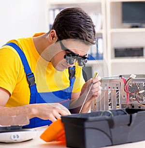 Computer repair technician repairing hardware