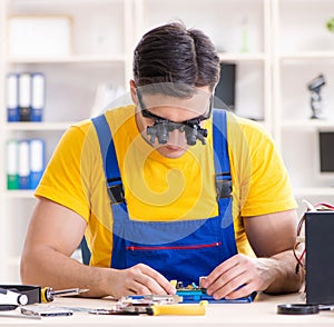 Computer repair technician repairing hardware