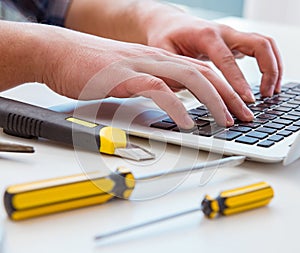 Computer repairman repairing computer laptop