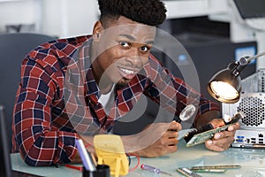 computer repairman using magnifying glass