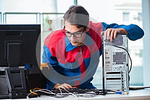The computer repairman working on repairing computer in it workshop