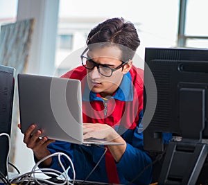 Computer repairman working on repairing computer in IT workshop