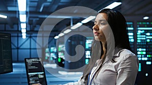 Computer scientist in data center monitoring security threats using computer