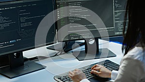 Computer scientist in data center monitoring security threats using computer