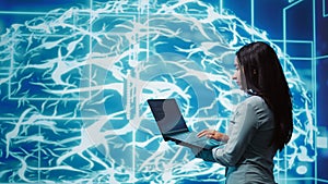 Computer scientist working on laptop, programming artificial intelligence