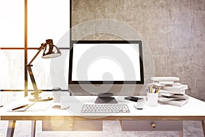 Computer screen, concrete wall, books, toned