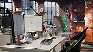 Computer screen in empty software development agency showing code