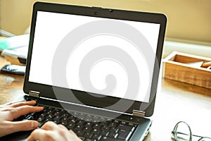 Computer screen mockup. Laptop with white blank screen on a wood desk, office background, copy space