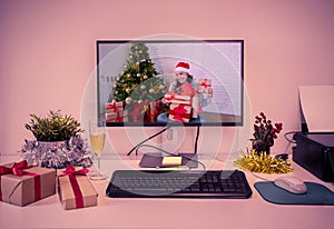 Computer screen with woman on video call celebrating Virtual christmas online at home