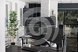 Computer screens showing parsing html code in empty it office