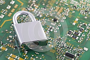 Computer security concept. Padlock on green computer circuit board